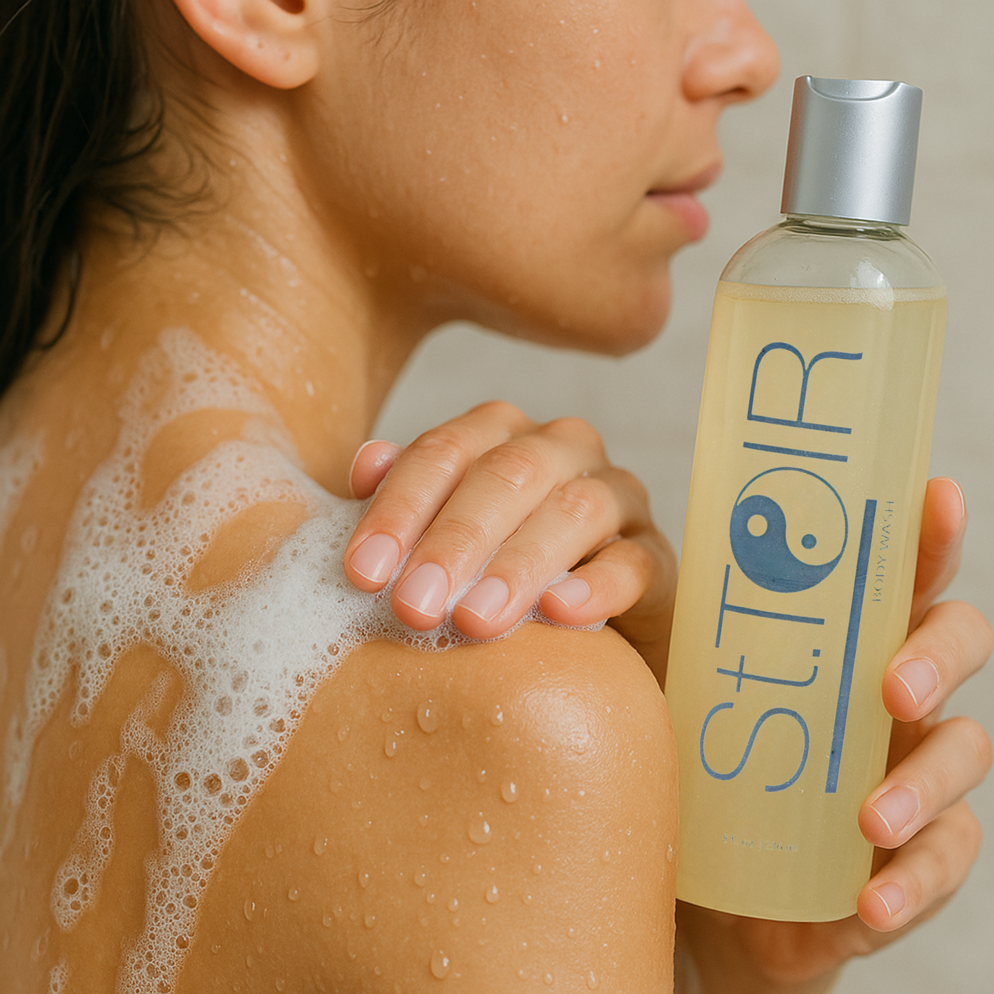 Person with soap suds on their shoulder holding a bottle labeled 'STIOR'.